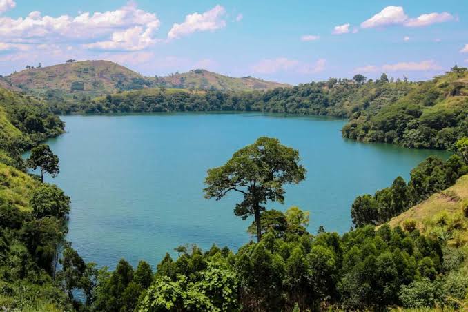 Lake Nyinambuga in western Uganda surrounded by lush green hills and beautiful crater lake scenery.